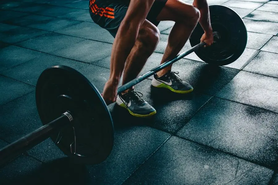 Person training with dumbbells representing active lifestyles that benefit from protein