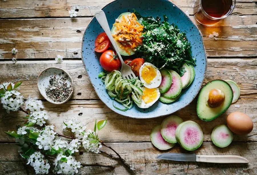 Fresh vegetables, fruits, and whole foods arranged for balanced daily nutrition