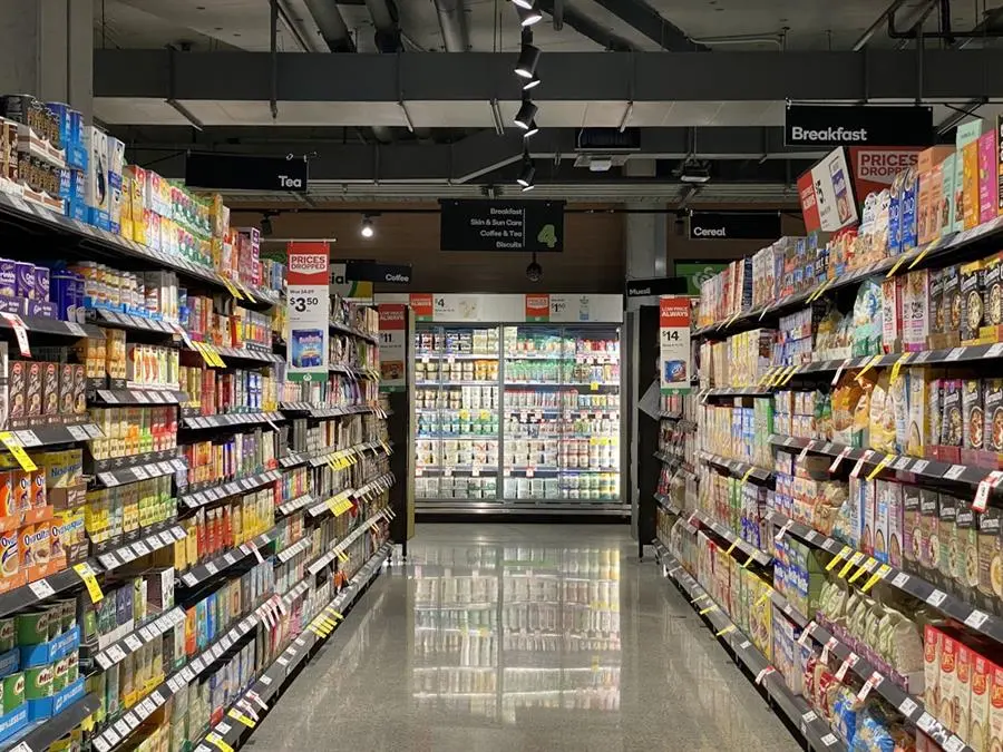 Grocery store aisle shelves stocked with packaged food products